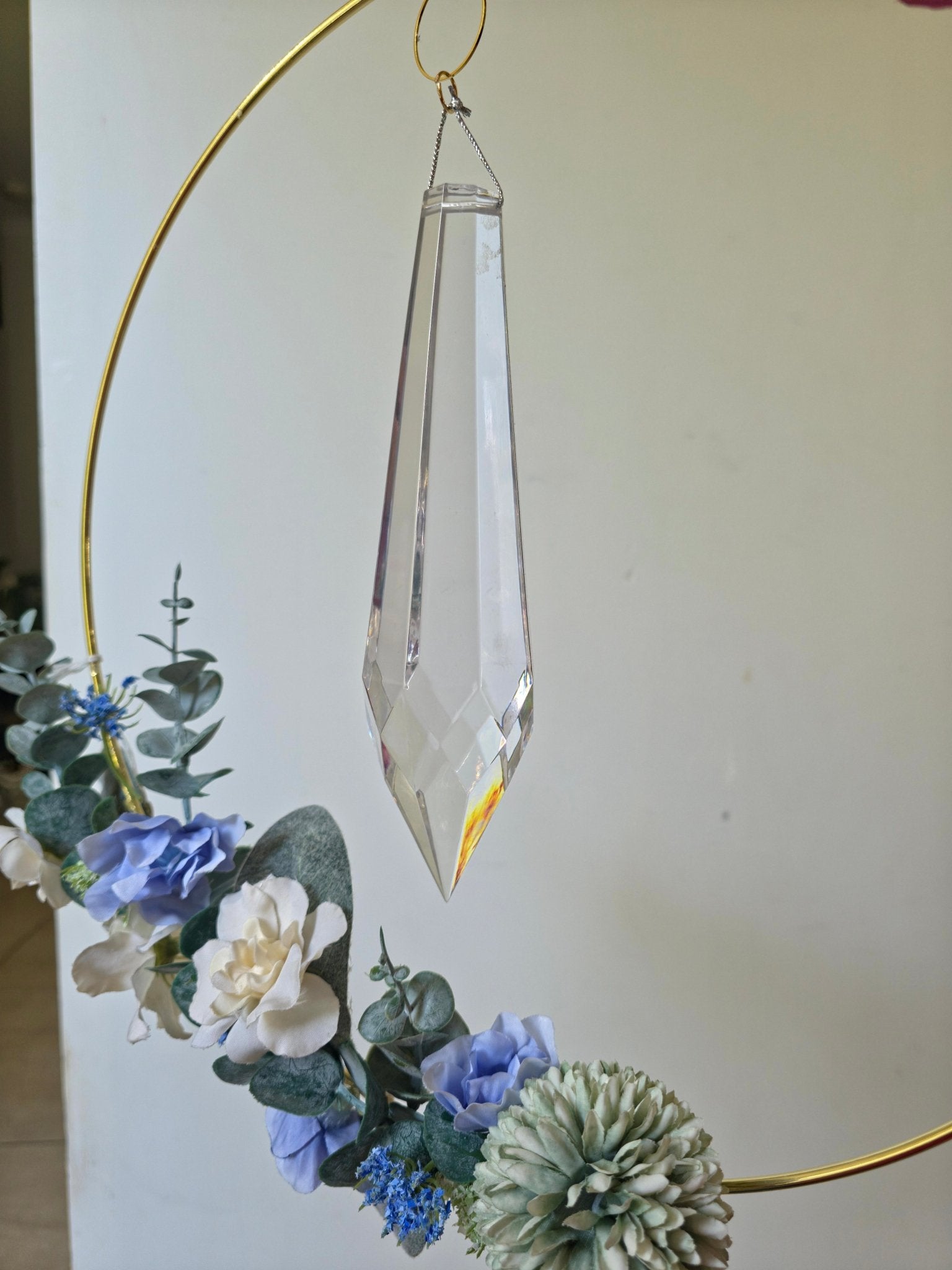 Close-up of Quiet Drift crystal prism and flowers